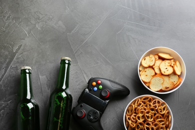 Photo of Flat lay composition with video game controller, snacks and space for text on grey background