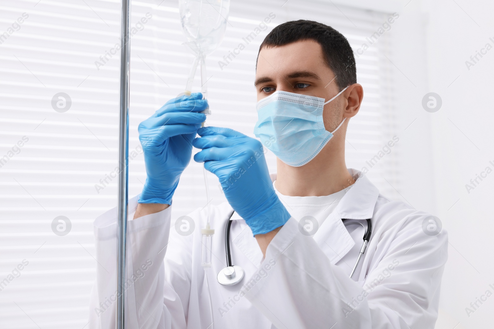 Photo of Doctor setting up IV drip in hospital