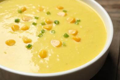 Delicious creamy corn soup on table, closeup