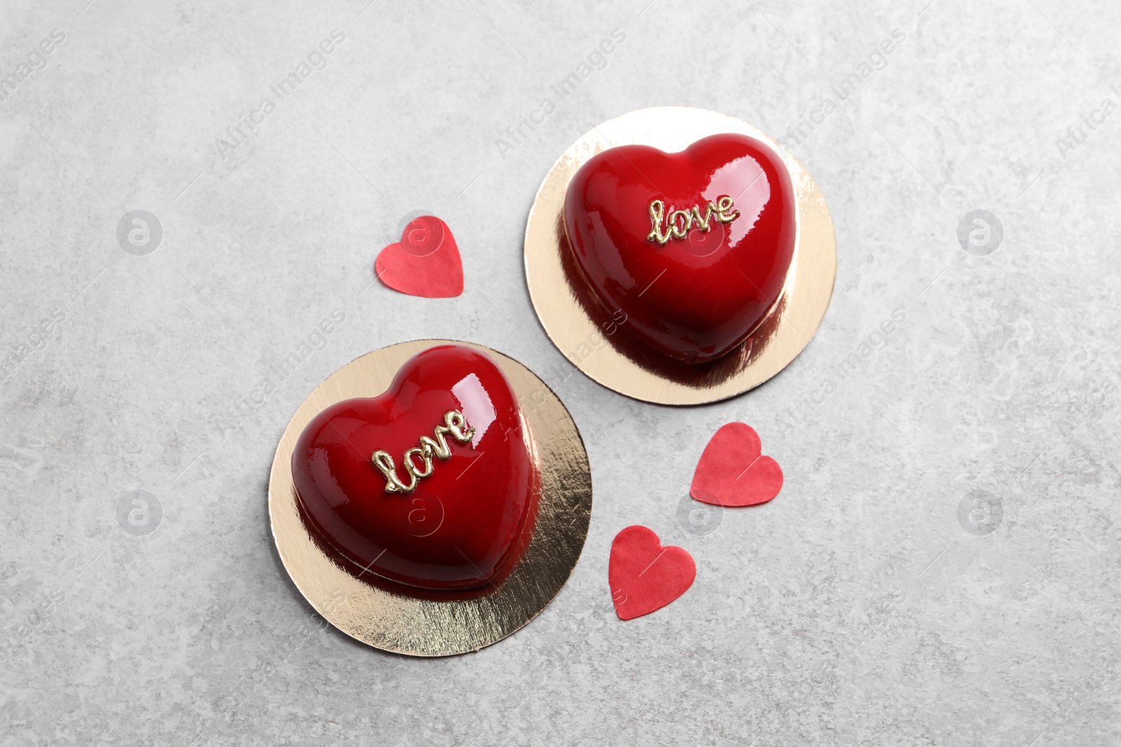 Photo of St. Valentine's Day. Delicious heart shaped cakes on light table, flat lay