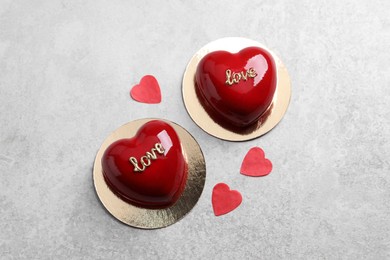 St. Valentine's Day. Delicious heart shaped cakes on light table, flat lay