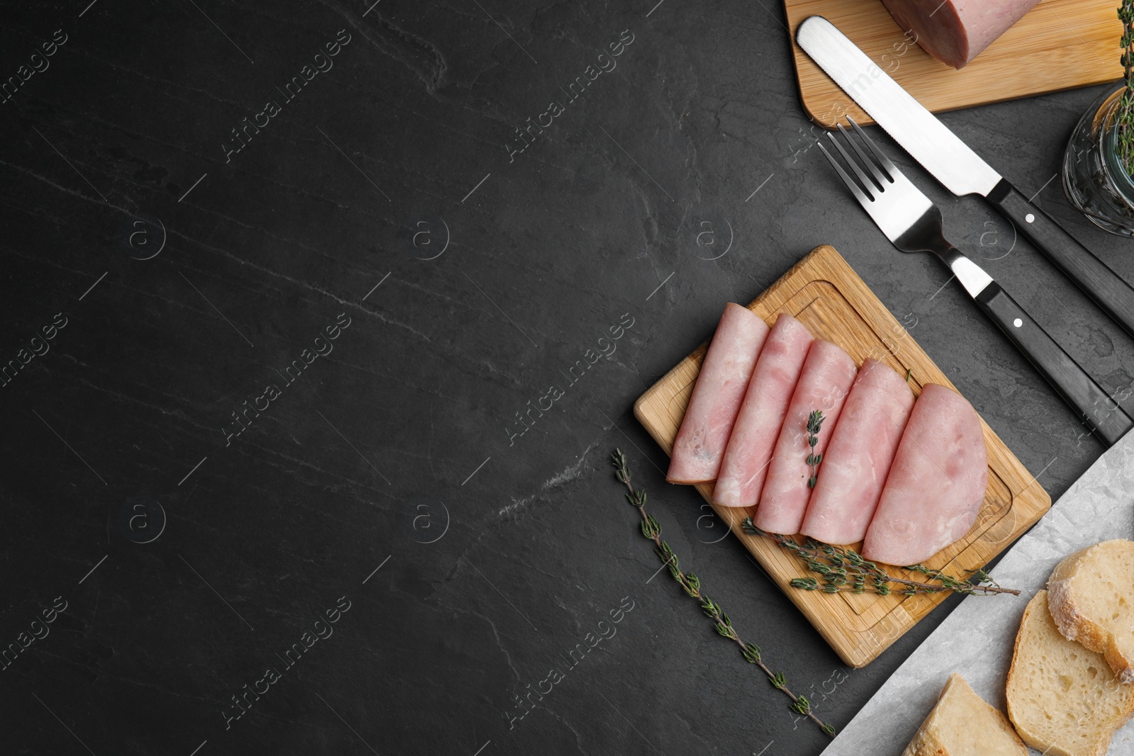 Photo of Tasty ham served on black table, flat lay. Space for text