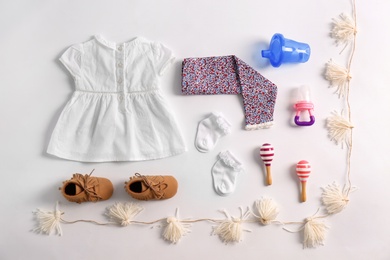 Set of baby clothes and accessories on light background, flat lay