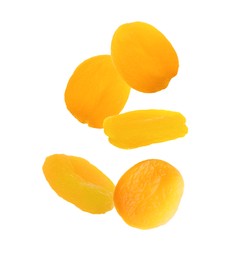 Many tasty dried apricots on white background