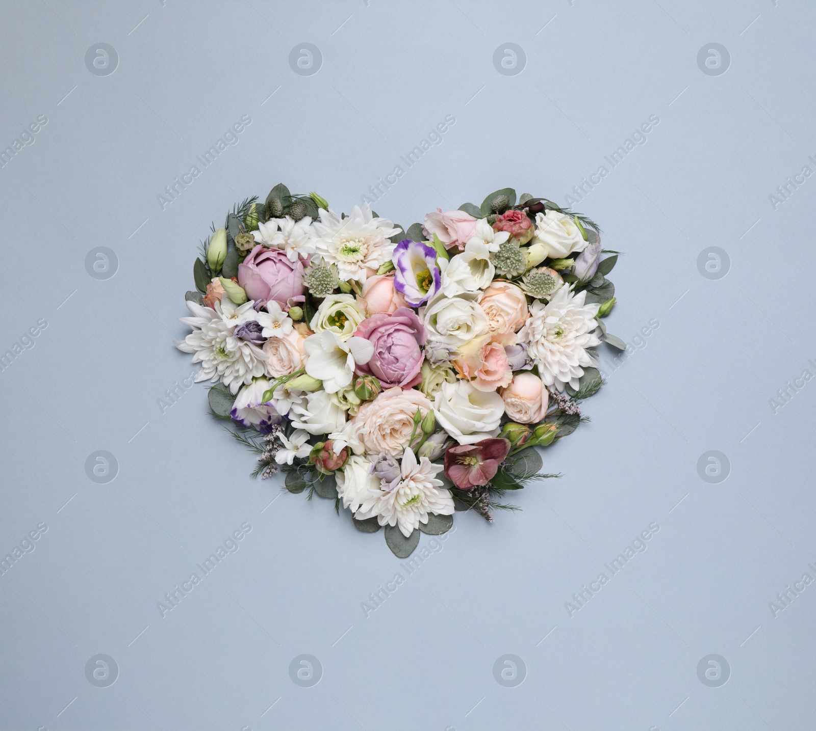 Photo of Beautiful heart made of different flowers on light gray background, top view