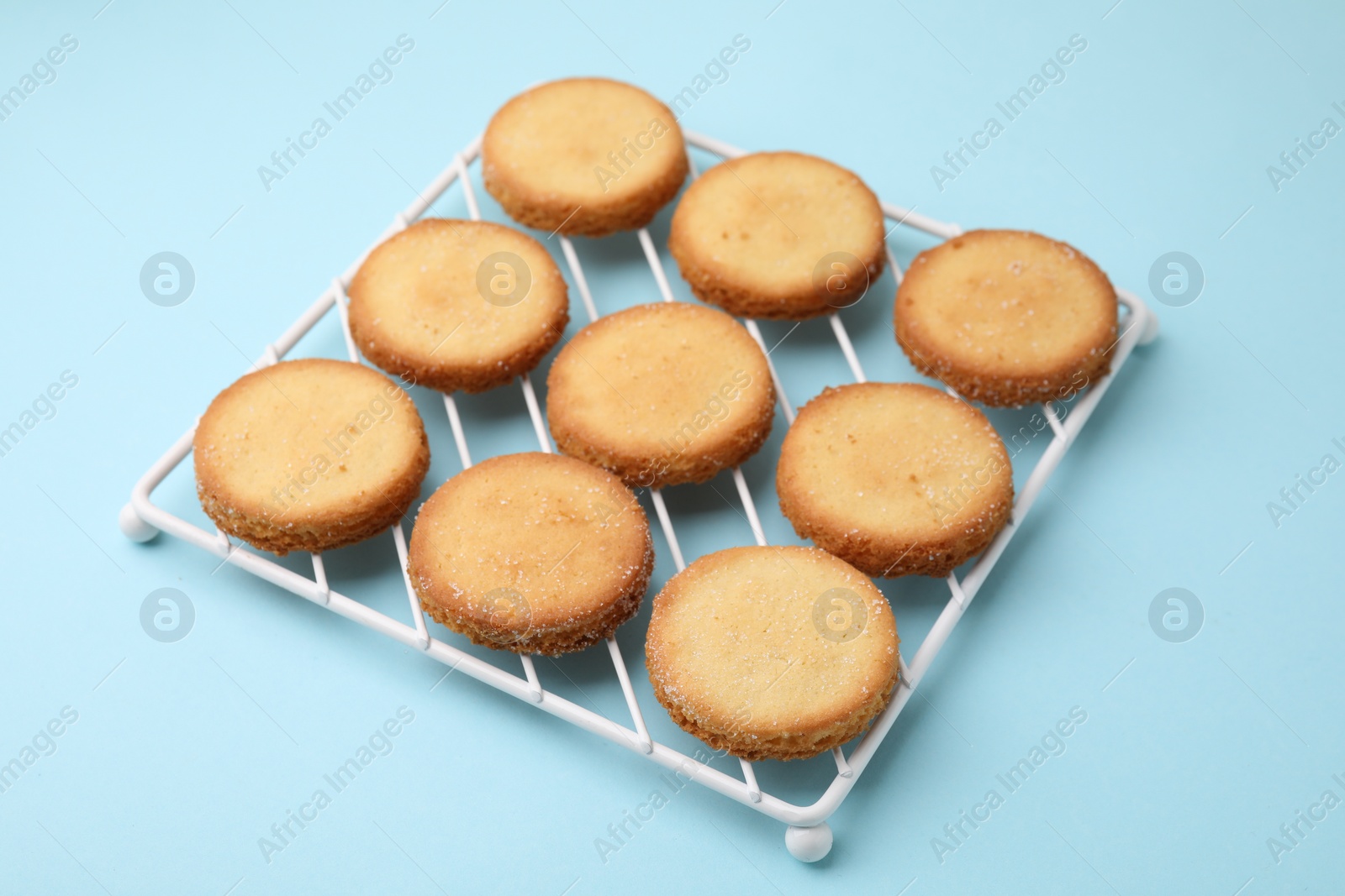 Photo of Tasty sweet sugar cookies on light blue background