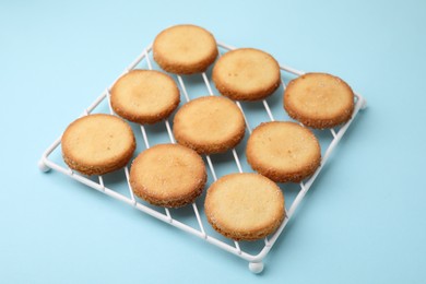 Photo of Tasty sweet sugar cookies on light blue background