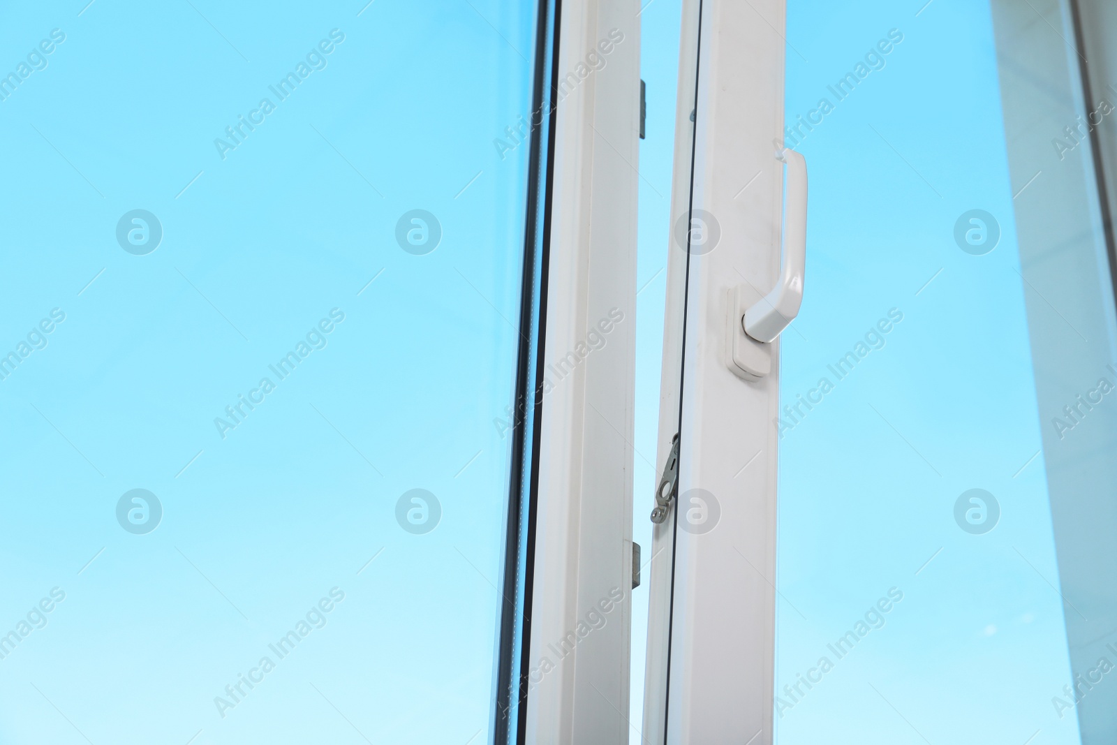 Photo of View of blue sky through modern window indoors