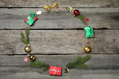 Frame of gift boxes and festive decor on wooden background, flat lay with space for text. Happy New Year