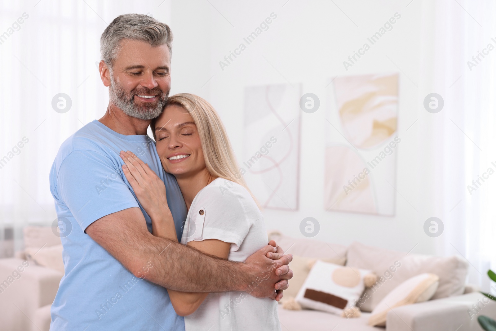 Photo of Portrait of happy affectionate couple at home, space for text. Romantic date