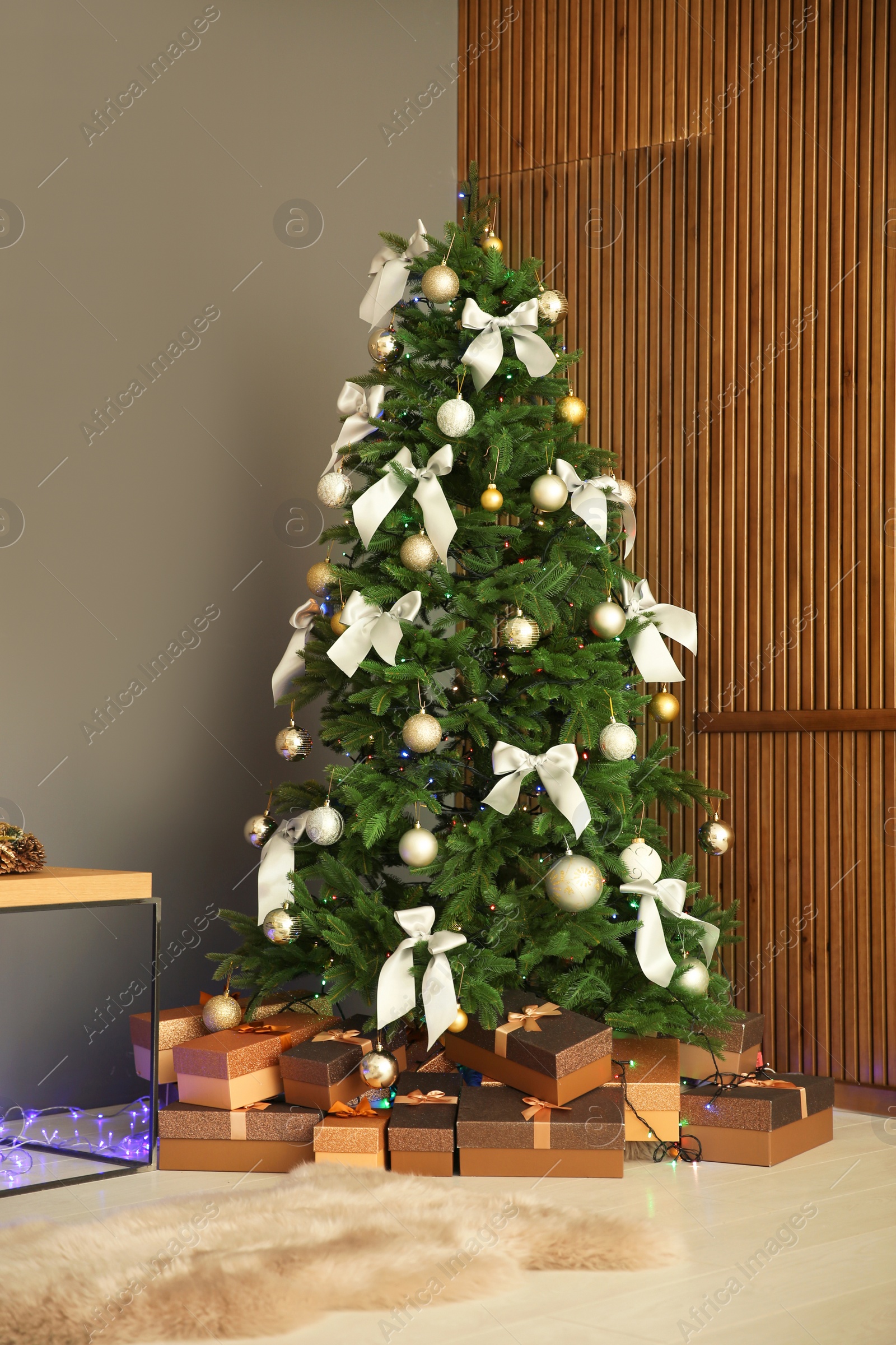 Photo of Beautiful Christmas tree and gift boxes indoors