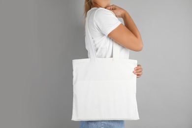 Photo of Woman with tote bag on grey background. Mock up for design