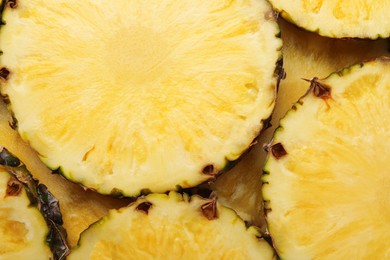 Photo of Slices of tasty ripe pineapple as background, top view