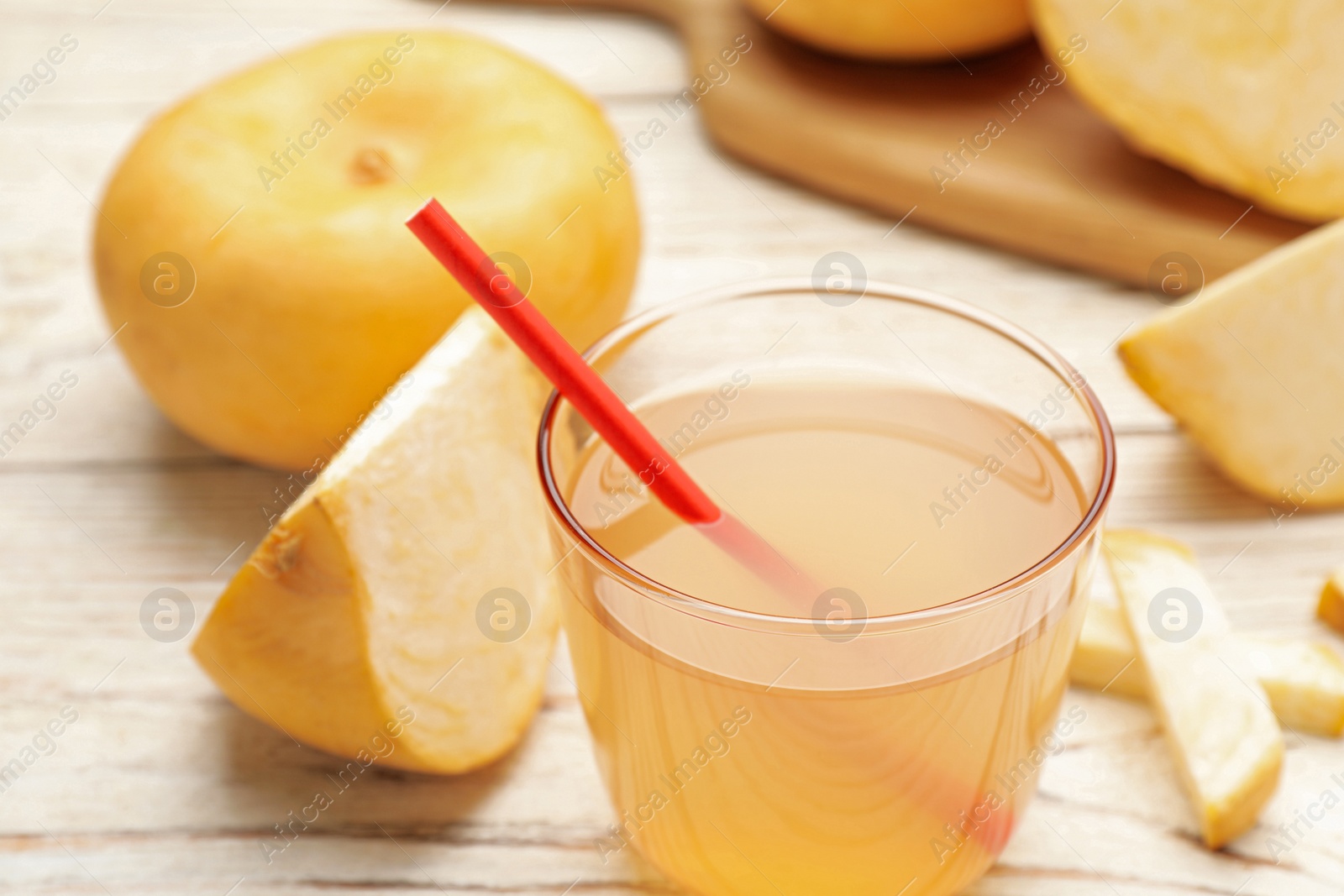 Photo of Glass of freshly made turnip juice on white table, closeup