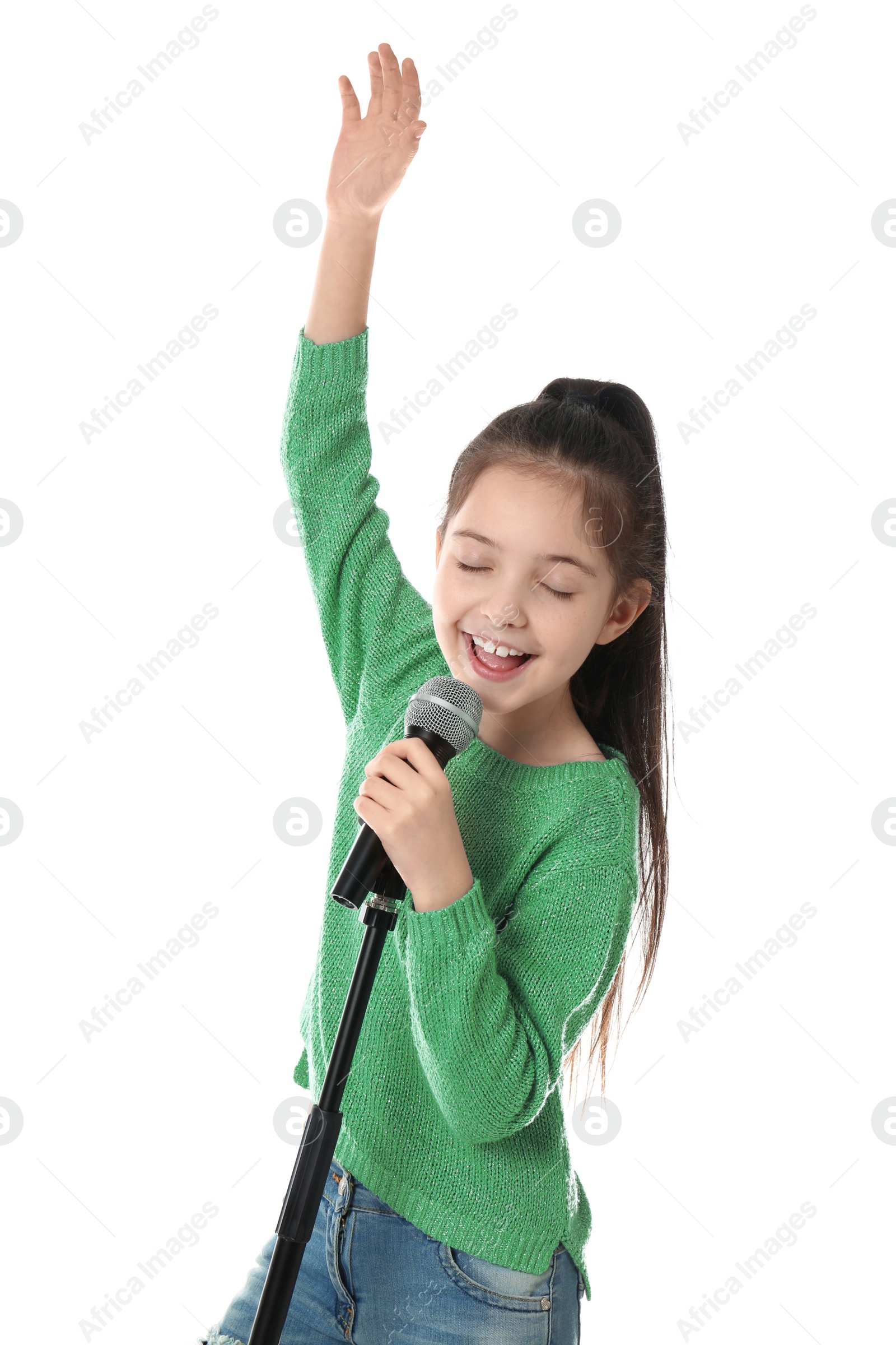 Photo of Little girl singing into microphone on white background