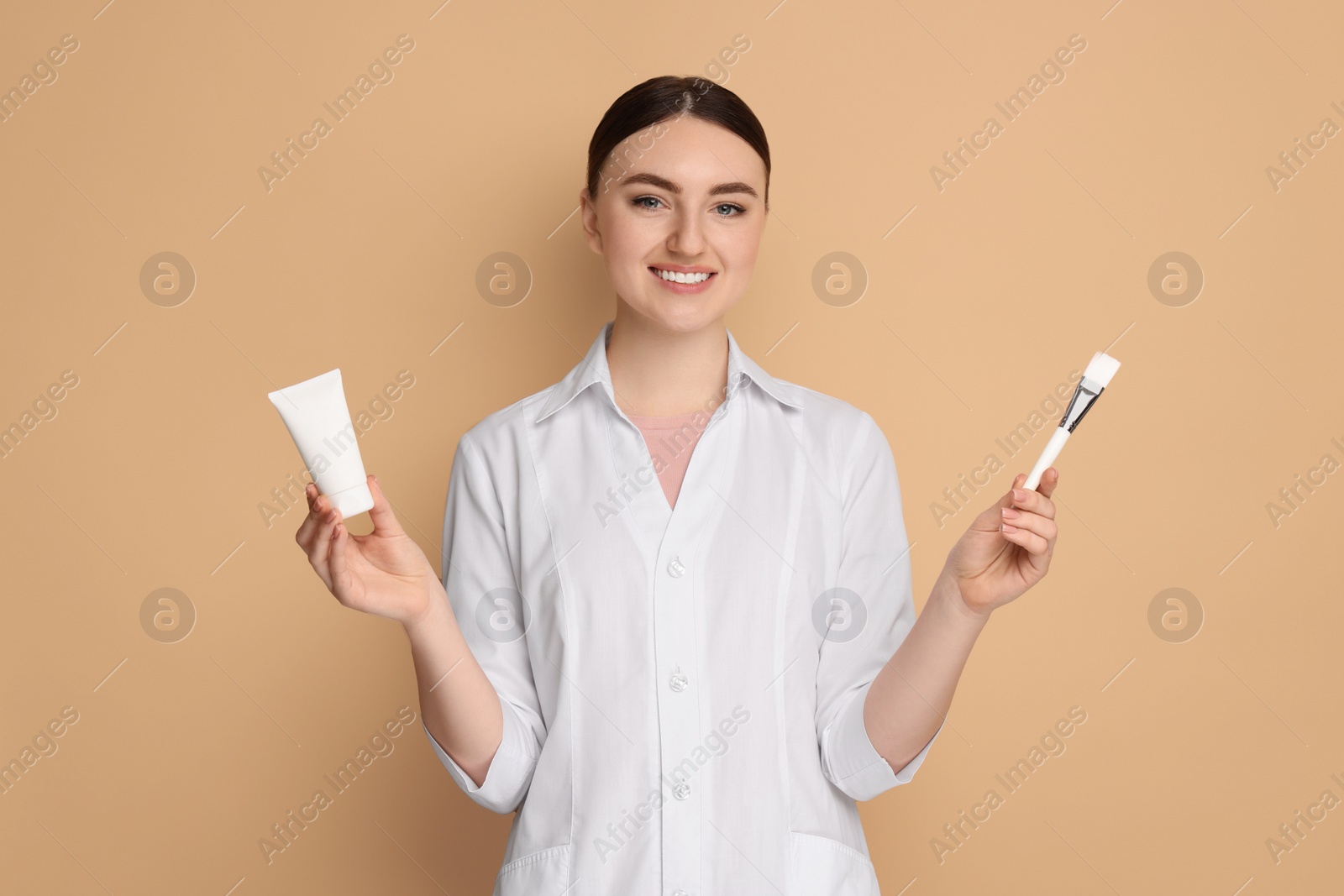 Photo of Cosmetologist with cosmetic product and brush on beige background