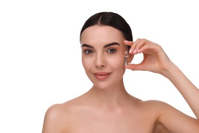 Photo of Beautiful young woman holding skincare ampoule on white background