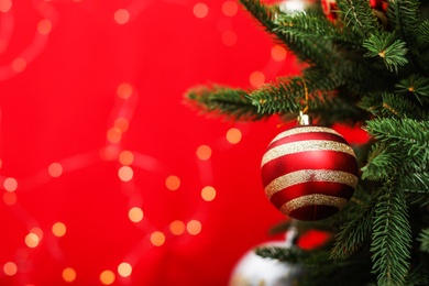 Photo of Decorated fir tree against blurred Christmas lights