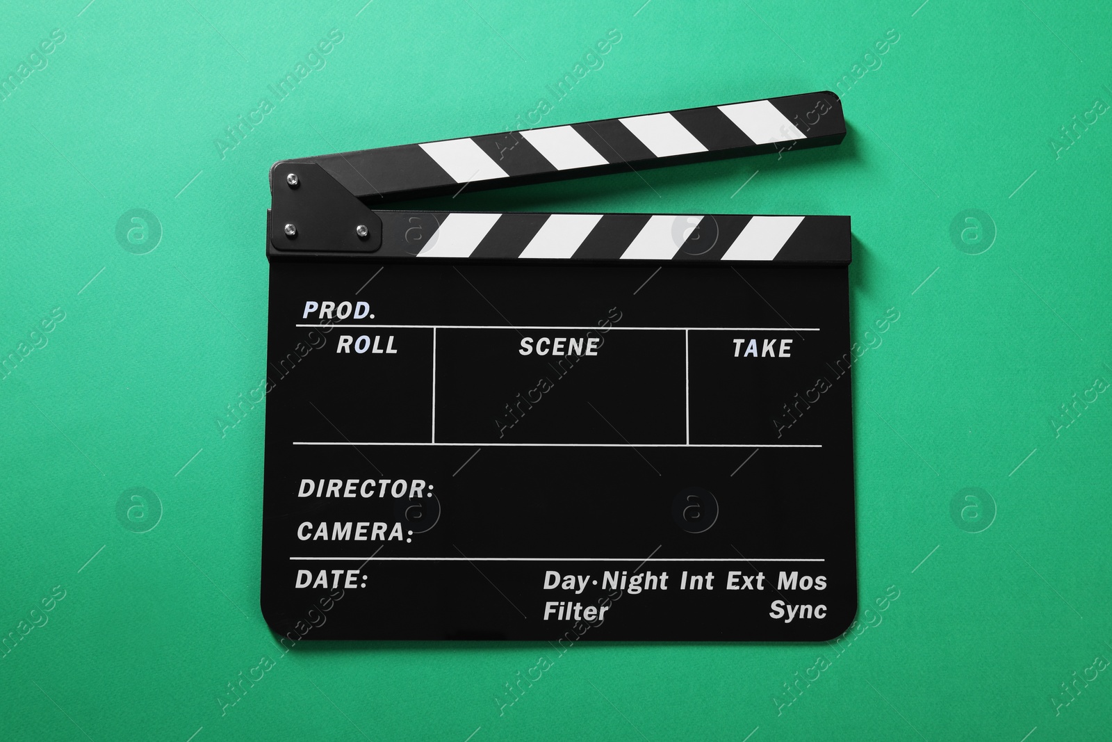 Photo of One clapperboard on green background, top view