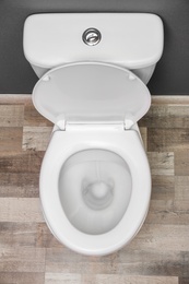 Photo of New ceramic toilet bowl indoors, top view
