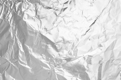 Photo of Crumpled silver foil as background, top view