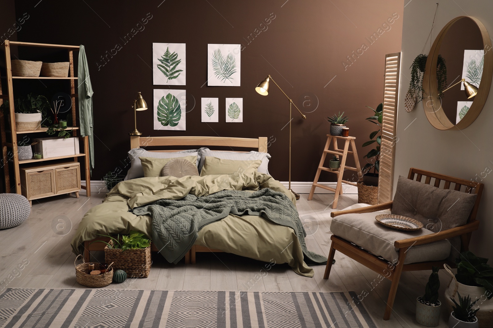 Photo of Stylish room interior with large bed and floral pictures