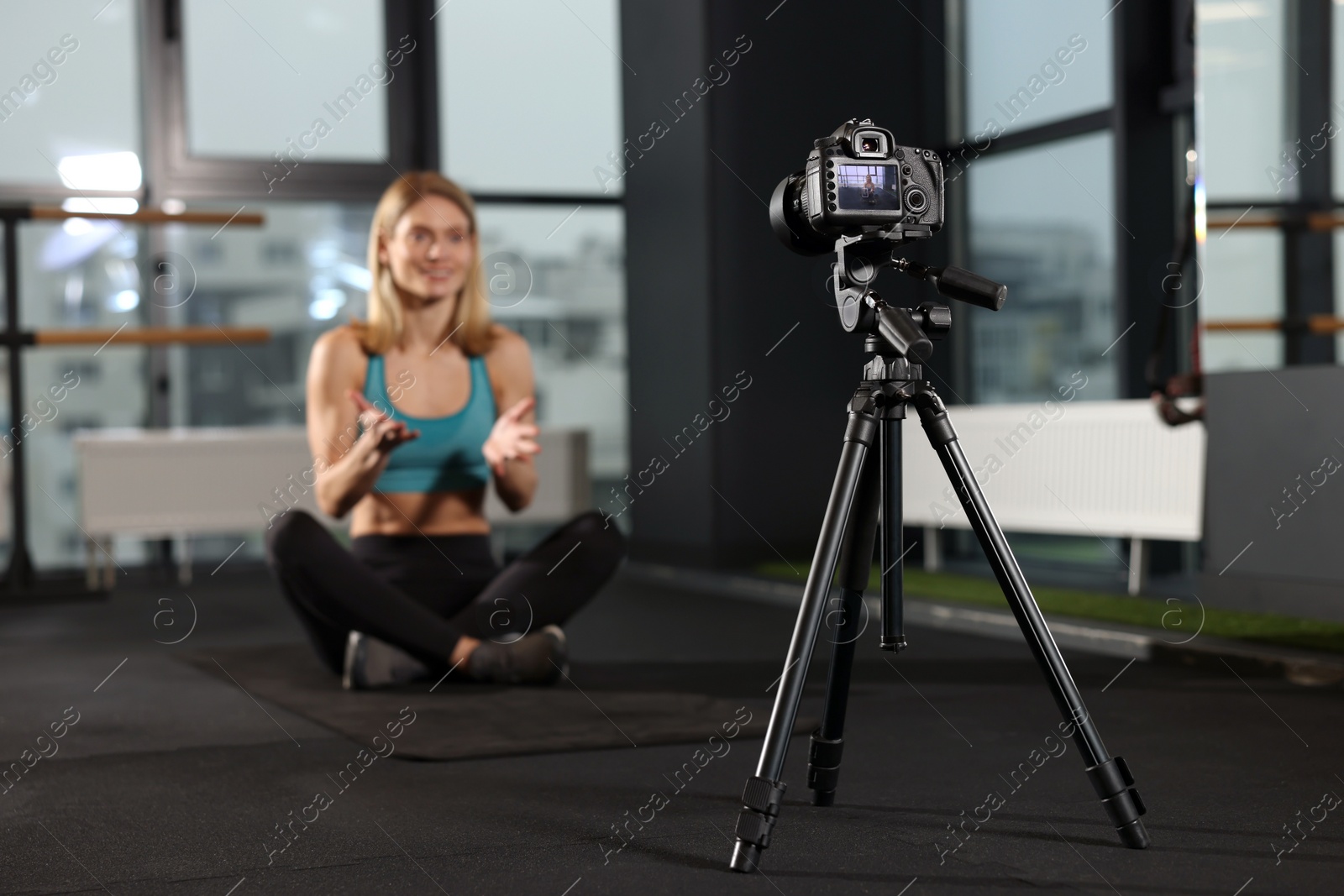 Photo of Fitness trainer recording online classes in gym