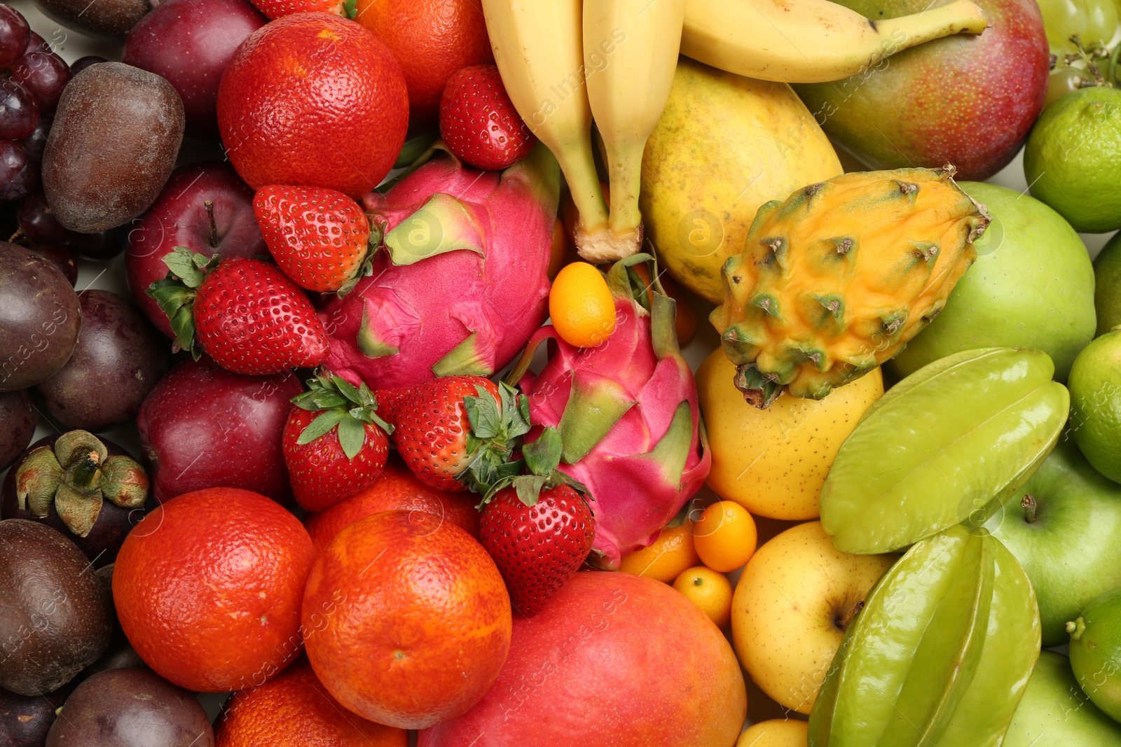 Photo of Assortment of fresh exotic fruits as background, top view