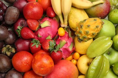 Assortment of fresh exotic fruits as background, top view