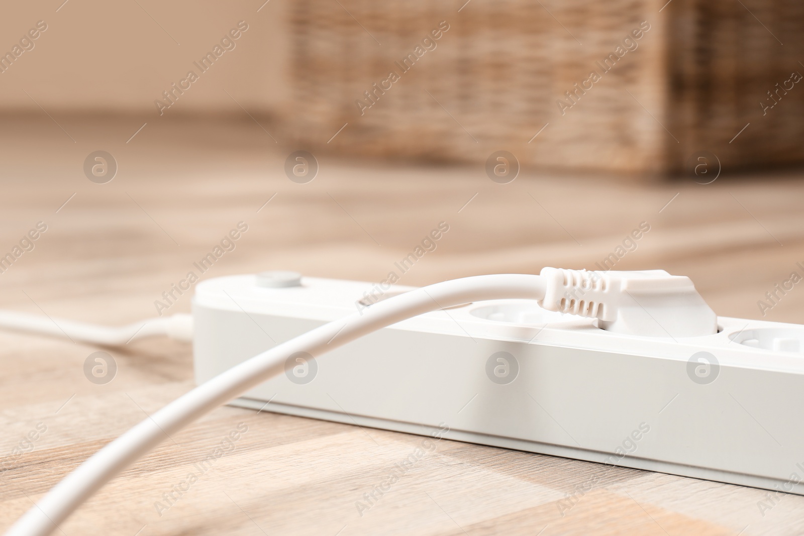 Photo of Extension cord on floor indoors, closeup. Electrician's equipment