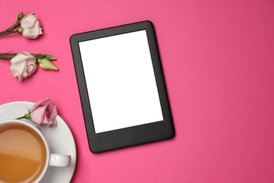 Photo of E-book reader with cup of tea and flowers on pink background, flat lay. Space for text