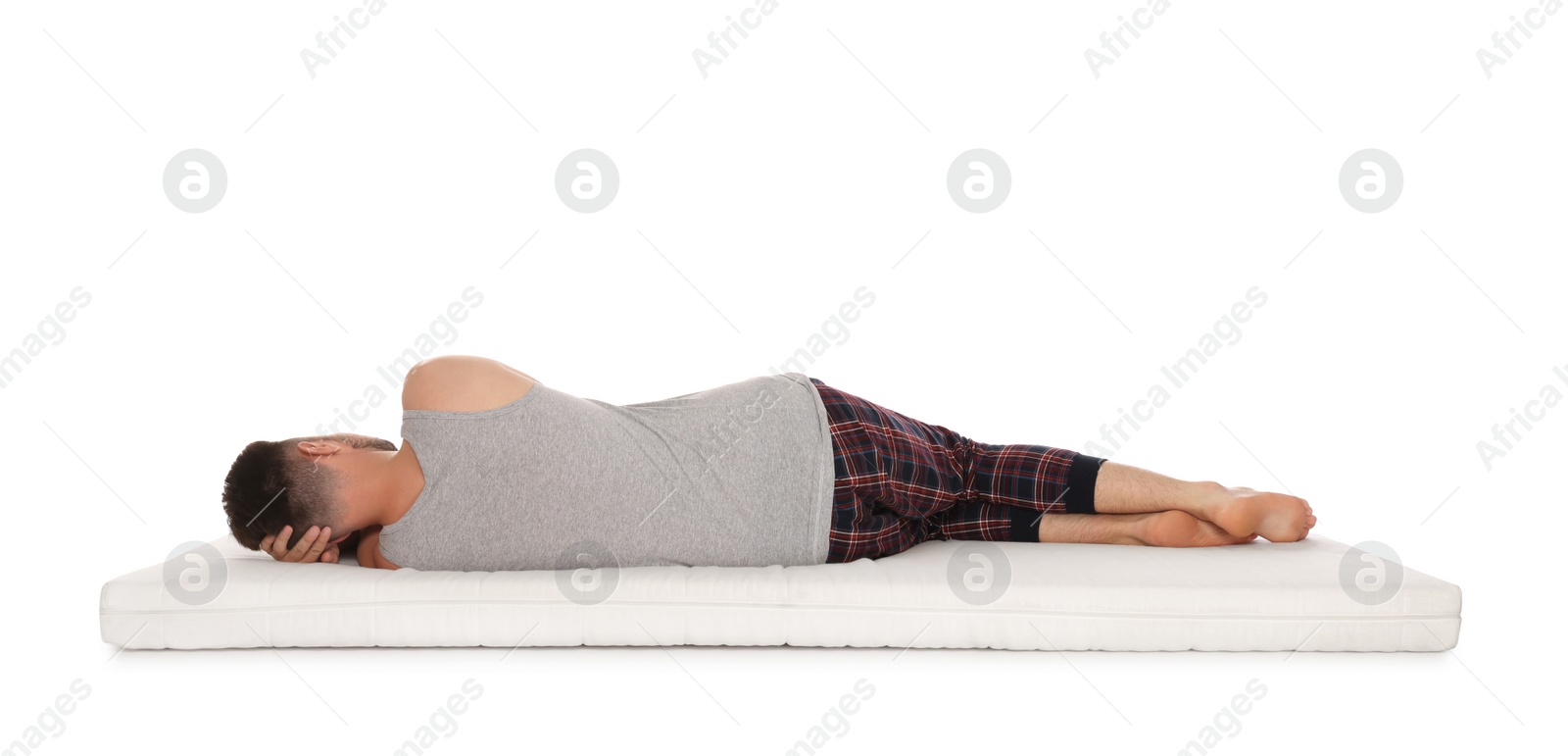 Photo of Man sleeping on soft mattress against white background, back view