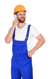 Professional repairman in uniform talking on smartphone against white background