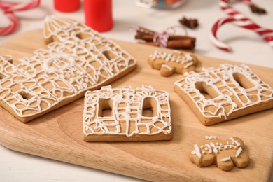 Photo of Parts of gingerbread house on wooden board, closeup