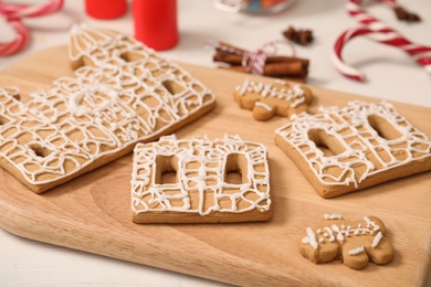 Parts of gingerbread house on wooden board, closeup