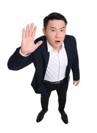 Businessman in suit posing on white background, above view