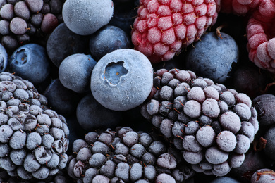 Mix of different frozen berries as background, top view