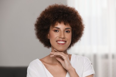 Portrait of beautiful young woman on blurred background