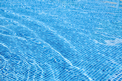 Photo of Swimming pool with clean blue water as background. Summer vacation