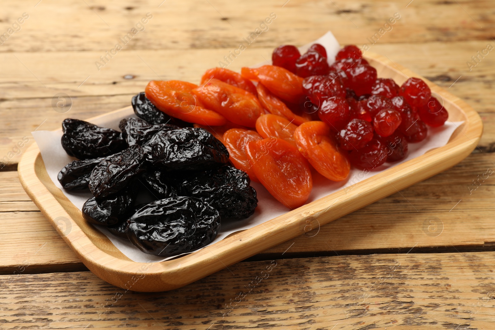 Photo of Delicious dried fruits on wooden table, closeup