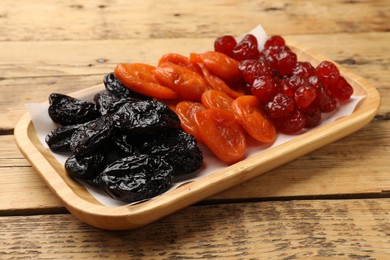 Delicious dried fruits on wooden table, closeup