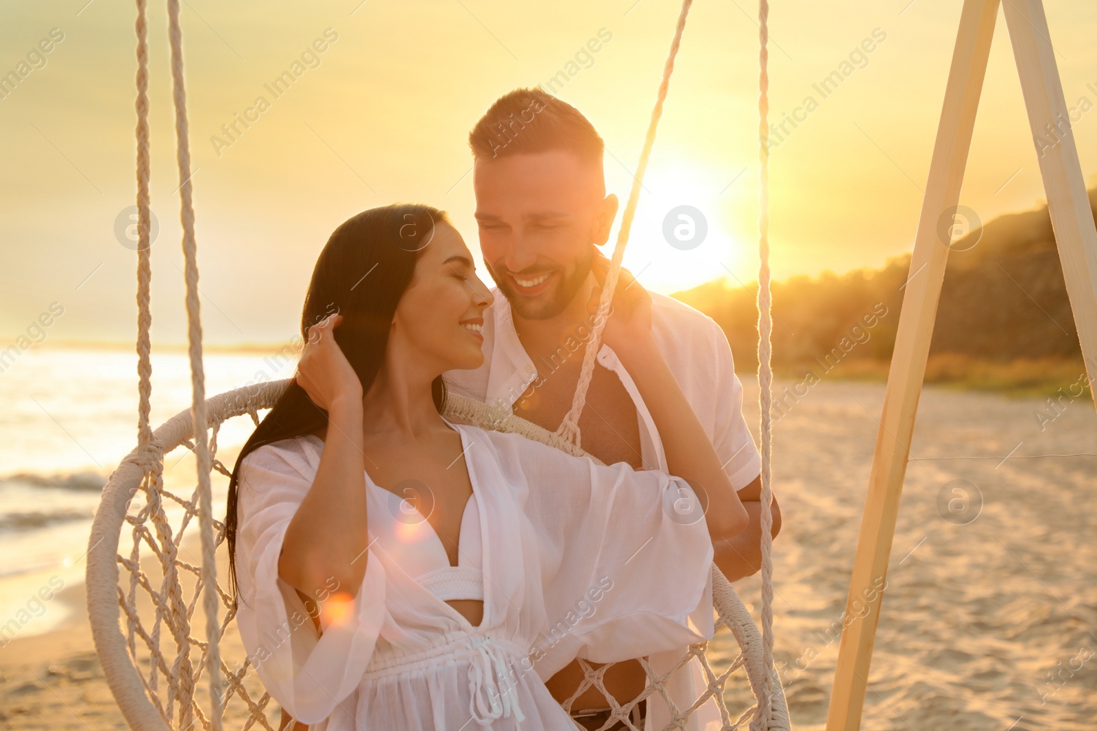 Photo of Happy young couple on beach at sunset