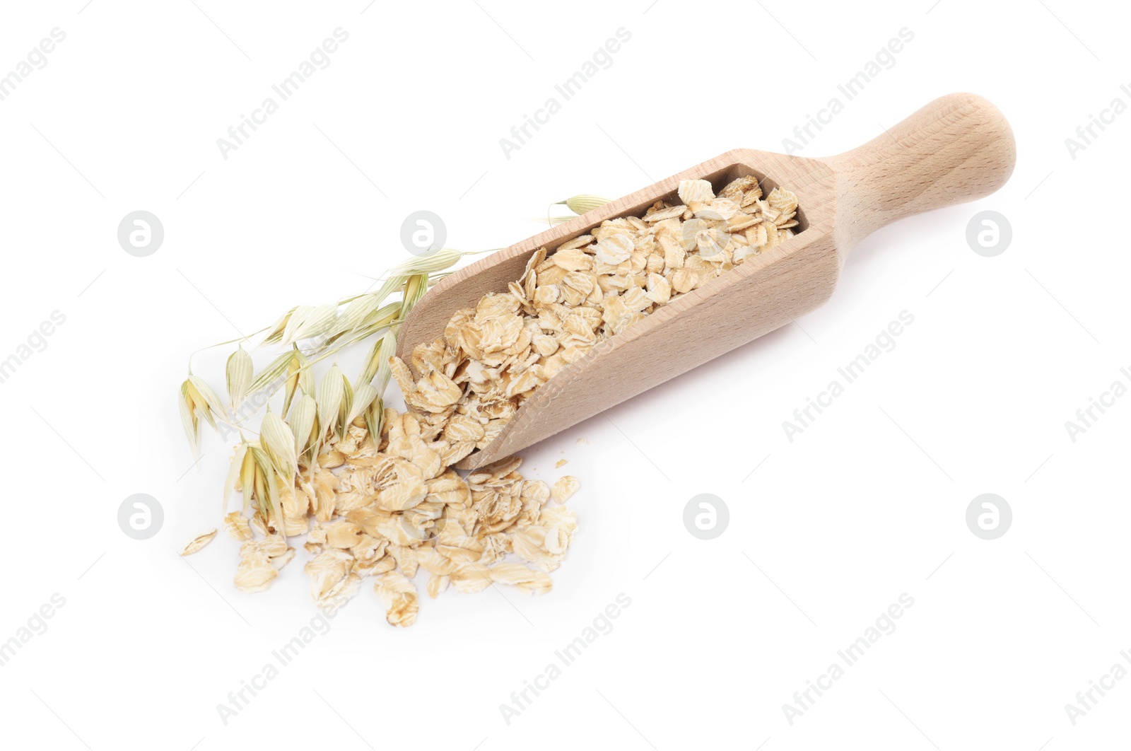 Photo of Scoop with oatmeal and floret branches isolated on white