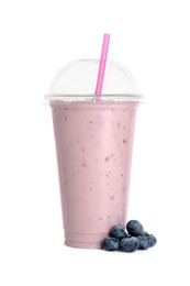 Photo of Plastic cup of tasty smoothie and fresh blueberries isolated on white