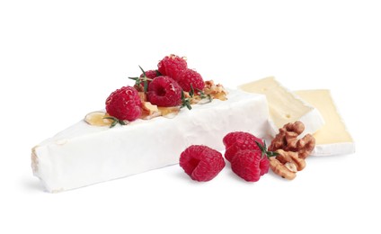 Photo of Brie cheese served with honey, raspberries and walnuts isolated on white
