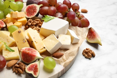 Photo of Set of different snacks with ripe figs served on table, closeup