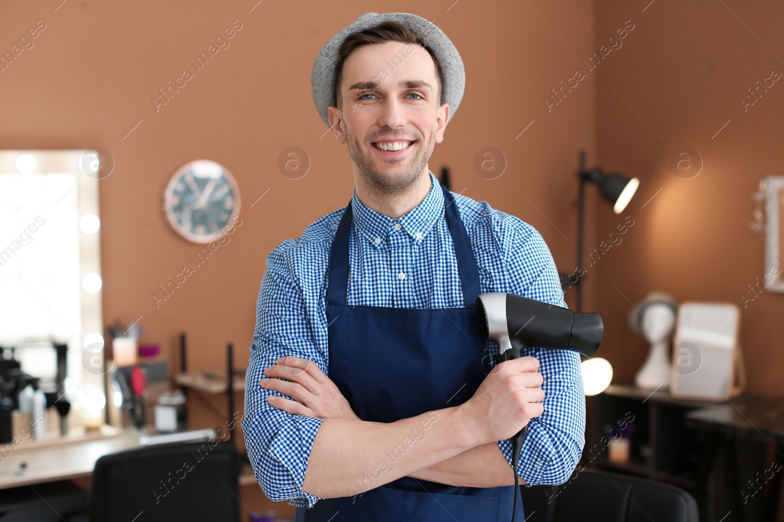 Photo of Professional hairdresser in beauty salon