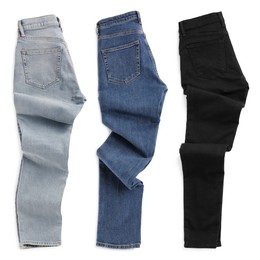 Image of Set with different jeans on white background, top view