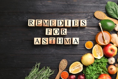 Natural products and cubes with space for text on wooden background. Home remedies for asthma