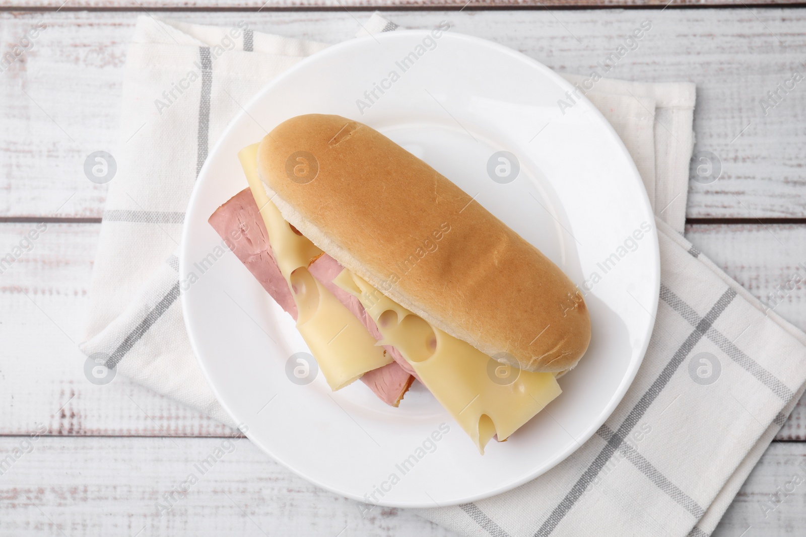 Photo of Delicious sandwich with ham and cheese on white wooden table, top view